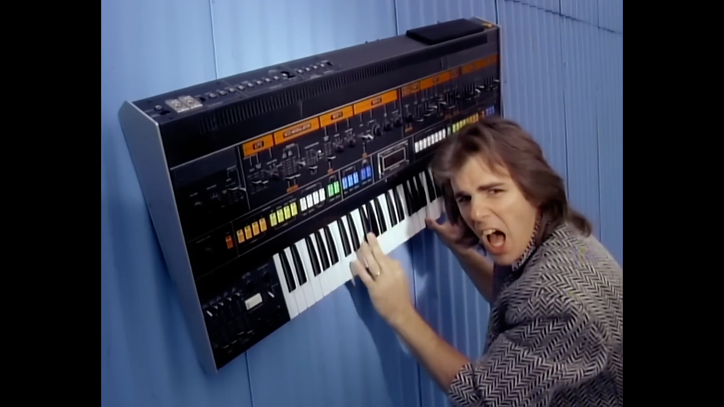 Jonathan Cain with vintage Roland Jupiter 8 in Separate Ways (Worlds Apart) Music Video for sale at Retro Gear Shop